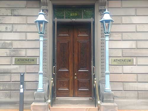 photo of the exterior double oak doors at The Athenaeum in Philadelphia after the doors were restored.