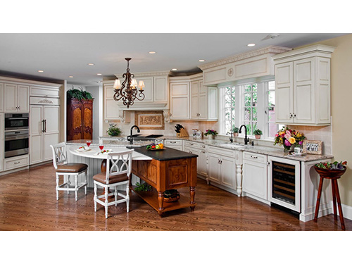 photo of kitchen - partial circle table, 2 chairs white cabinets and ceiling and hardwood floors