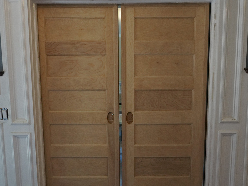 photo of oak panel doors in wall before painting