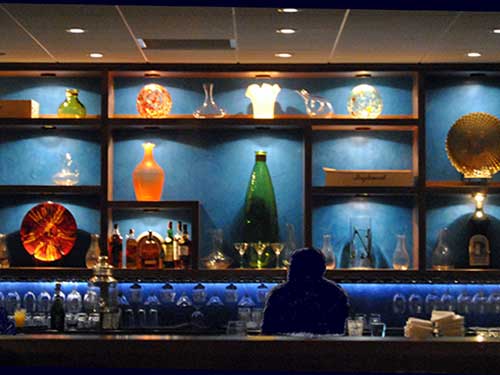 photo of bar with blue venetian plaster wall behind it
