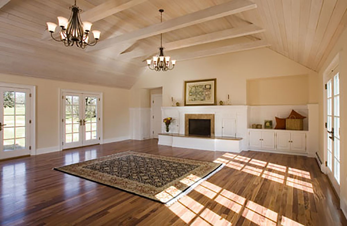 photo of Great Room showing entertainment center cabinetry, pickled wood ceiling, ceiling beams