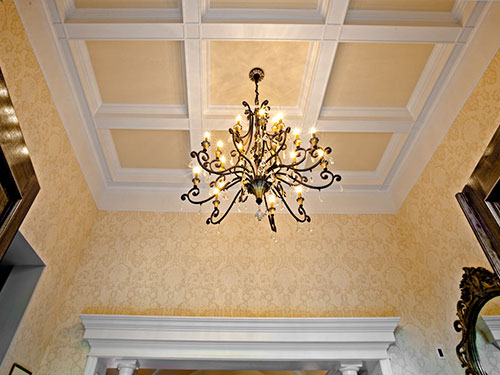 photo of Coffered Ceiling and Chandelier Detail with beautiful golden wallcoverings