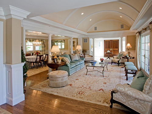 photo of great room with barrel vault ceiling painted light peach,  open to the left to dining room and straight ahead to foyer. 