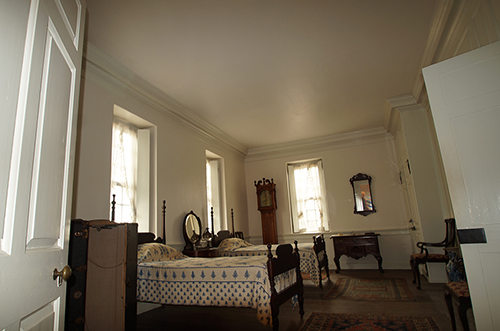 photo of bedroom at Hope Lodge painted white with colonial revival furniture