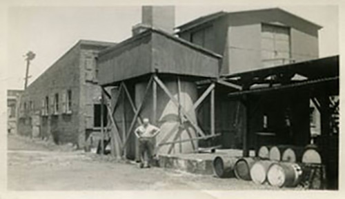 C Schrack Factory with man standing in front