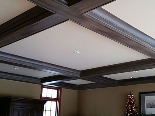 photo of mahogany stained beams on a coffered white ceiling