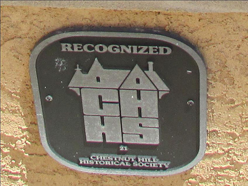 plaque below window on St Martin's Lane reading Recognized 21 Chestnut Hill Historical Society.