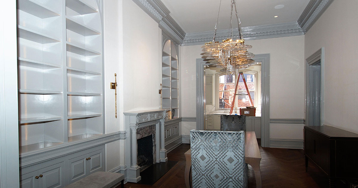 photo of dining room with fireplace to the left surrounded by cabinets painted in light blue from Fine Paints of Europe