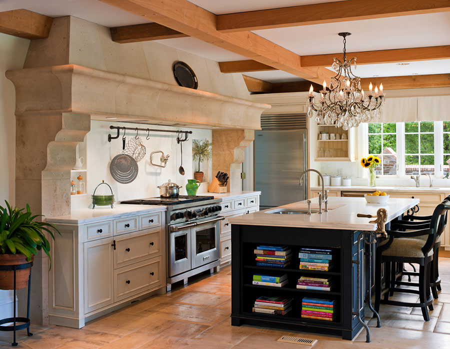 photo of kitchen painted in yellow with center island and exposed beams