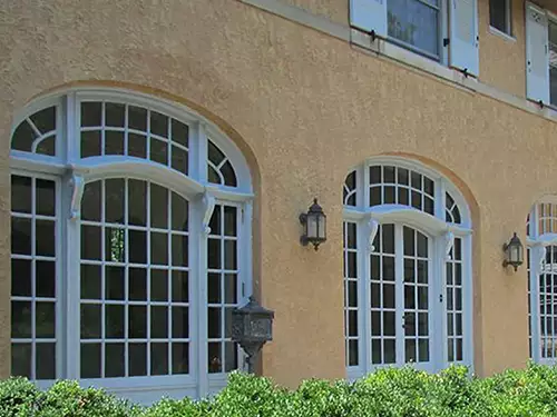 photo of arched windows in courtyard painted white